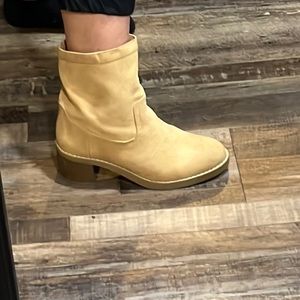 cowboy boot inspired low boot with classy piping around the boot.